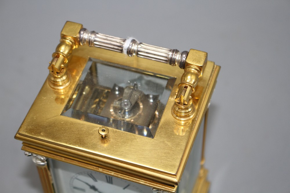 A 20th century silvered and gilt quarter repeating carriage clock